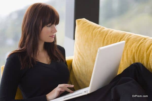 A young woman working at home on her laptop computer.
