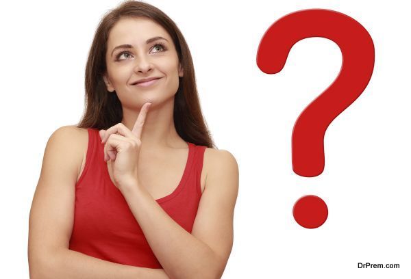 Thinking girl looking up with red question sign near her
